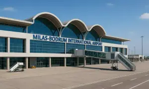 Nowoczesny budynek lotniska Milas-Bodrum International Airport z niebieskimi oknami i falistym dachem.